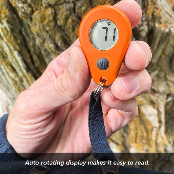 Thermodrop-outdoor-hiking-ultralight Orange ThermoDrop thermometer held beside a tree