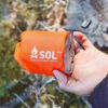 Emergency_Bivvy_Orange_in_hand_outdoor.jpg SOL - Emergency Bivy