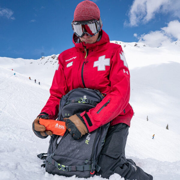 Emergency_Bivvy_Orange_ski_patroller_pulling_from_backpack.jpg SOL - Emergency Bivy